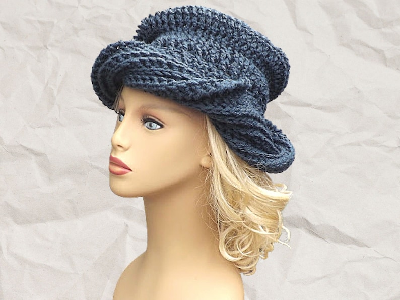 a mannequin head wearing a blue crocheted hat