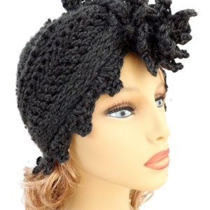 a mannequin head wearing a black crochet hat