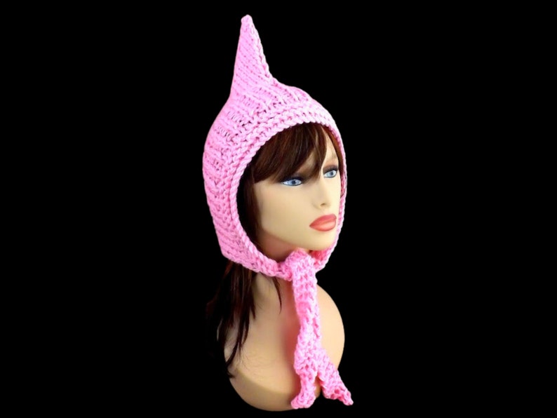 a pink knitted pixie hood hat on a mannequin head