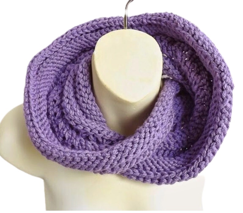 a purple knitted scarf on a mannequin