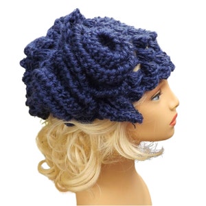 a mannequin head wearing a blue crocheted hat