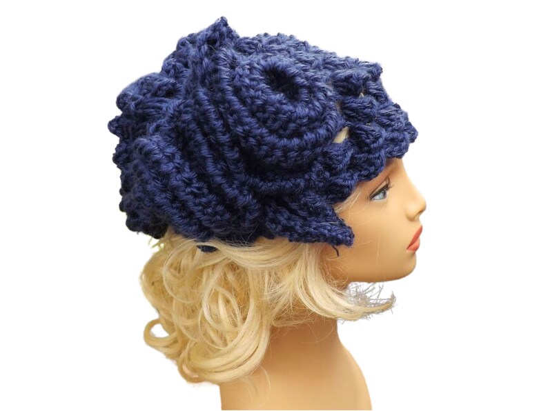 a mannequin head wearing a blue crocheted hat