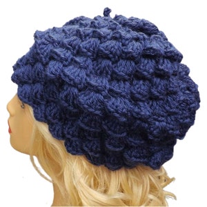 a mannequin head wearing a blue crocheted hat