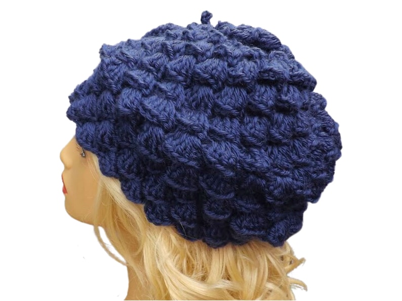 a mannequin head wearing a blue crocheted hat