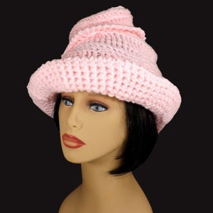 Back angle view of a pastel pink Virginia Mobius crochet cloche hat pattern worn on a mannequin, displaying the hat's intricate Mobius strip design