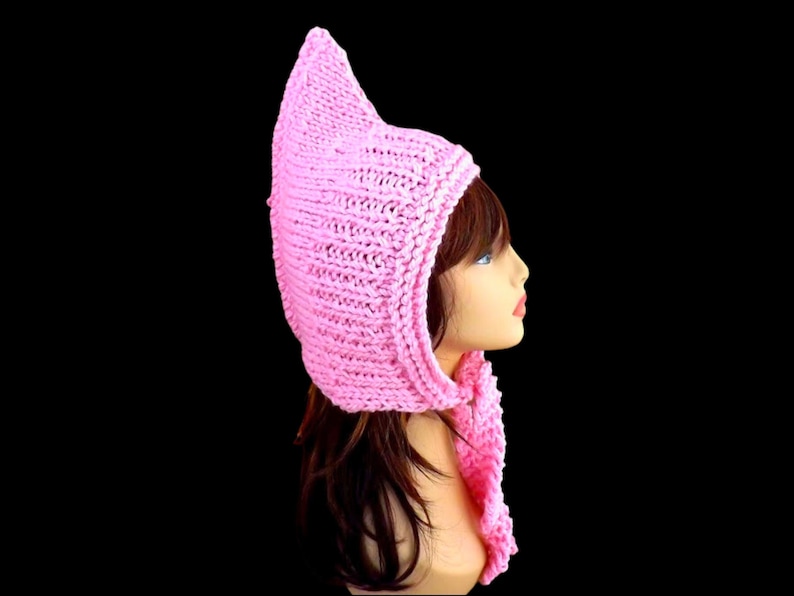 a pink knitted pixie hood hat on a mannequin head