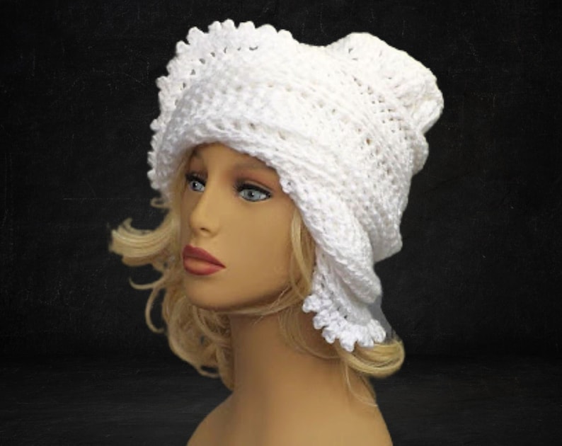 Three-quarter view of a mannequin head donning a white 1960s Lisa design Mobius crochet hat, exuding timeless elegance with its intricate pattern and flapper style