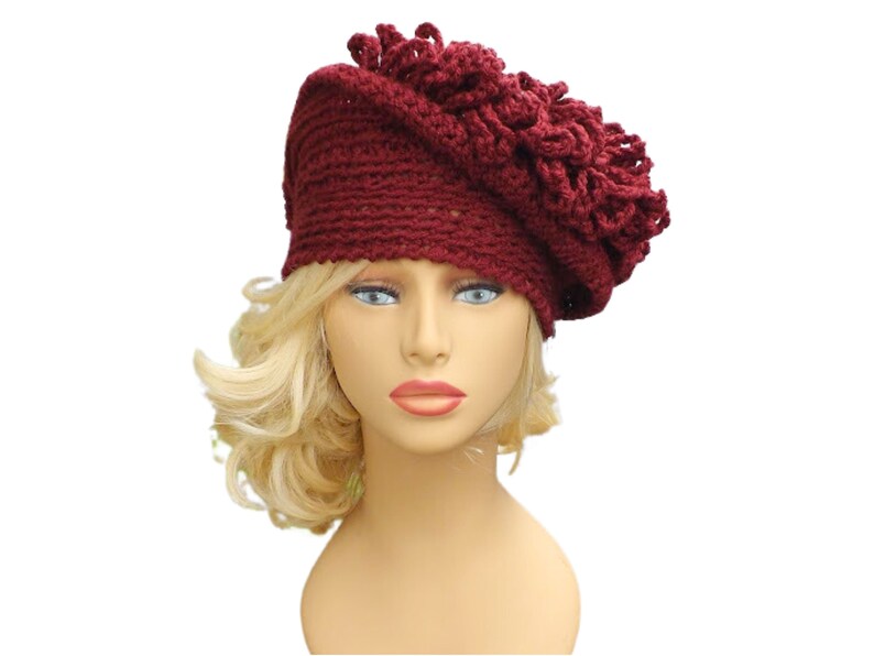 a mannequin head wearing a burgundy crocheted hat