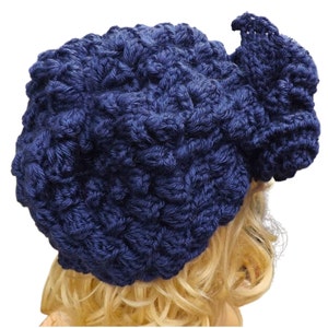 a mannequin head wearing a blue crocheted hat