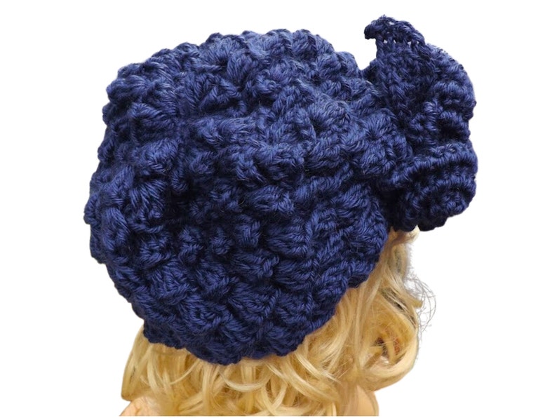 a mannequin head wearing a blue crocheted hat