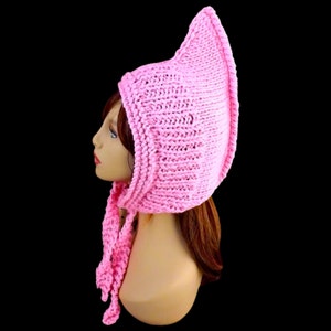 a pink knitted pixie hood hat on a mannequin head