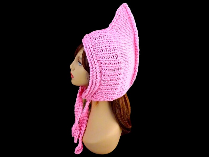 a pink knitted pixie hood hat on a mannequin head