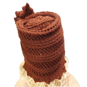 a crocheted hat on a mannequin head