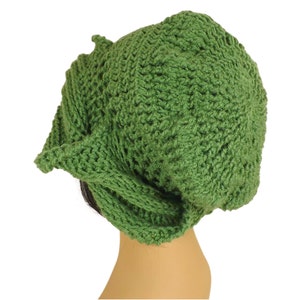 Unique Möbius Crochet Hat Pattern - Samantha Slouchy Beanie with Twist Brim. A handmade green crochet hat shaped like a slouchy beanie, shown from the side view against a plain white background.