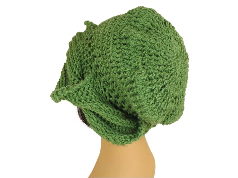 Unique Möbius Crochet Hat Pattern - Samantha Slouchy Beanie with Twist Brim. A handmade green crochet hat shaped like a slouchy beanie, shown from the side view against a plain white background.