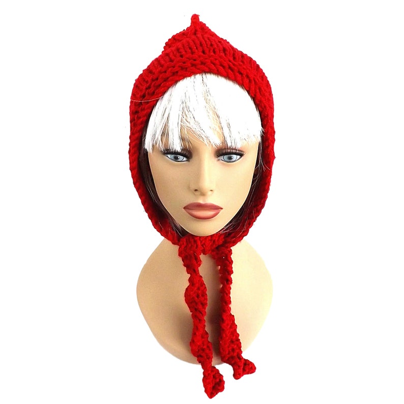 a mannequin head wearing a red knitted hat