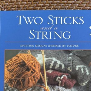 May include: Book cover with the title "Two Sticks and a String" and a photo of knitting needles and yarn. The book is about knitting designs inspired by nature.