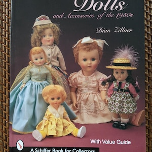 May include: A book cover featuring the title "Dolls and Accessories of the 1950s" by Dian Zillner. The cover displays several vintage dolls in various outfits. The book is labeled "A Schiffer Book for Collectors" and includes a "With Value Guide".