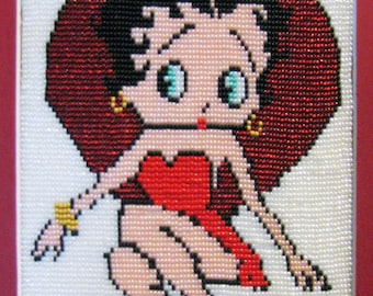 Puede incluir: Una imagen de cuentas rojas y blancas de una mujer de dibujos animados con un vestido rojo y zapatos rojos. La mujer tiene el pelo negro y grandes ojos azules.