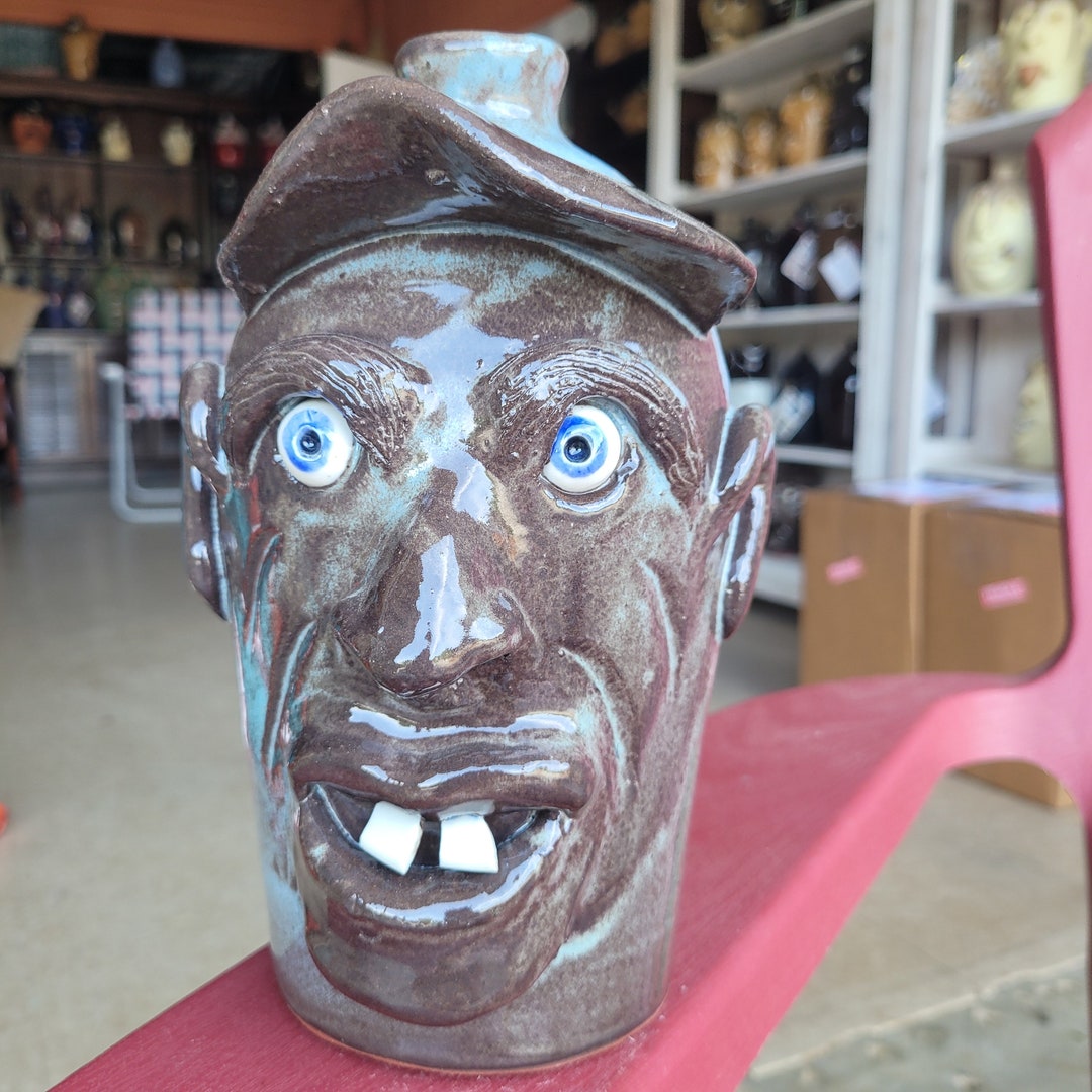 Folk Pottery Dark Brown With Light Blue Streaks Glazed Face Jug With Hat by Billy Joe Craven 9.5