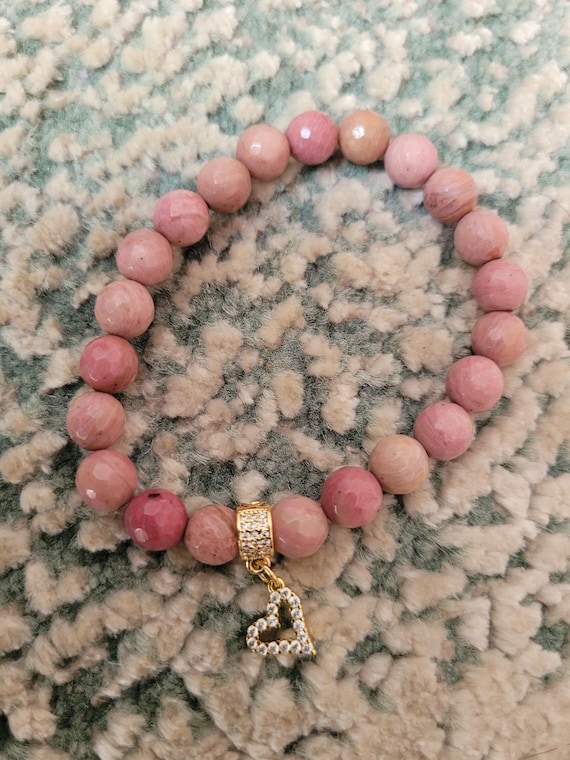 Energetically LOVING faceted rhodochrosite beads complimenting cz paved gold plated heart charm and bead stretch, stacking bracelet.
