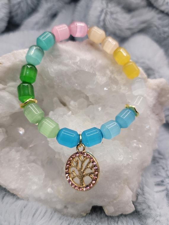 Energetically UPLIFTING natural multicolored cat's eye beads complimenting gold plated cz paved tree of life stretch stack bracelet