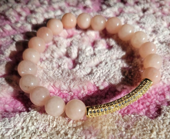 Energetically INSPIRING peach jade beads with cz paved gold plated noodle focal bead stretch bracelet