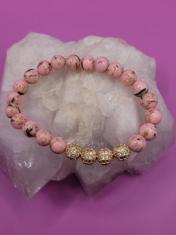 Energetically ELEVATING pink shell turquoise beads accented rhinstone studded gold beads bracelet.