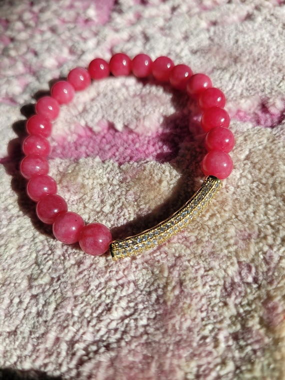 Energetically INSPIRING bright pink jade beads with cz paved gold plated noodle focal bead stretch bracelet