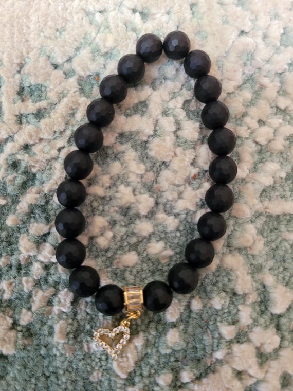 Energetically GROUNDING faceted onyx beads complimenting cz paved gold plated heart charm and bead stretch, stacking bracelet.