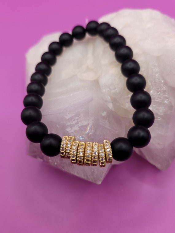 Energetically EMPOWERING matte black onyx with cubic zirconia studded gold flat disk beads as centerpiece bracelet