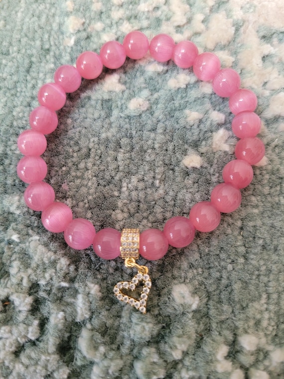 Energetically LOVING pink jade beads complimenting cz paved gold plated heart charm and bead stretch, stacking bracelet.