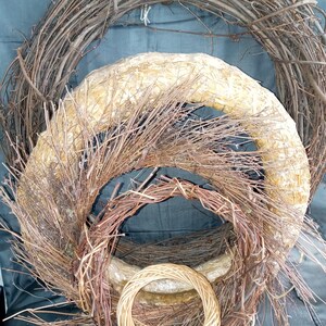 May include: Three woven wreaths of varying sizes, made from natural twigs and branches. The largest wreath is brown, the middle wreath is light brown, and the smallest wreath is a light brown wicker.