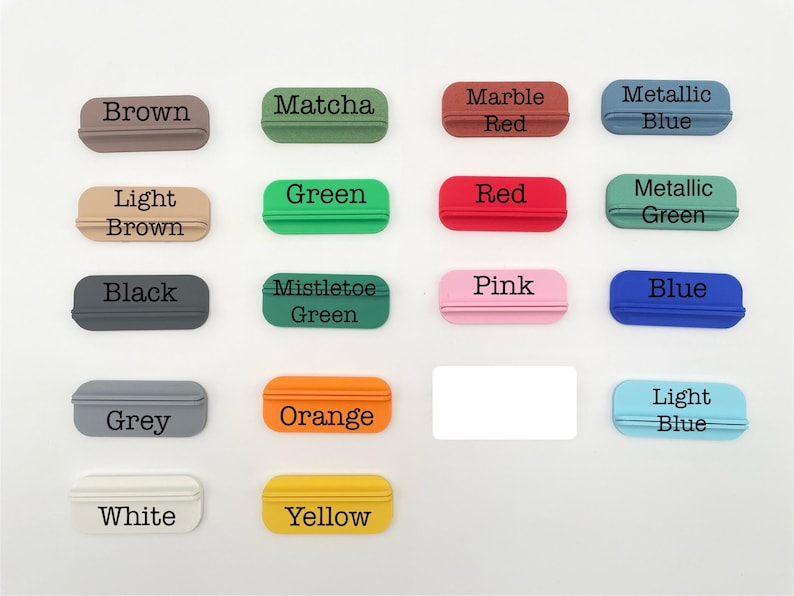 May include: A collection of small, rectangular objects in various colors, each labeled with a corresponding color name in black text. Colors include brown, green, red, blue, and more. The objects have a small, curved handle.