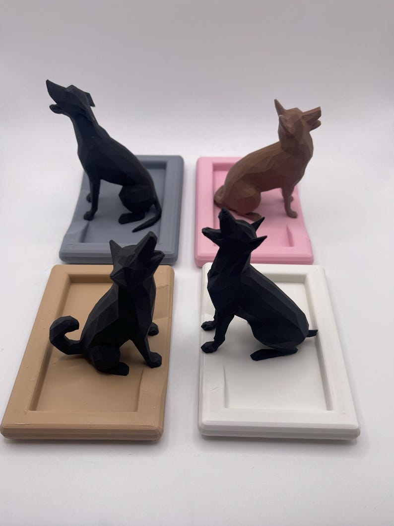 Puede incluir: Cuatro figuras geom&eacute;tricas de perros en negro y marr&oacute;n, cada una sobre una base rectangular en gris, rosa, beige y blanco. Los perros est&aacute;n en varias poses, algunos sentados y otros de pie con la cabeza levantada.