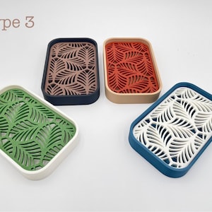 May include: Four rectangular soap dishes with leaf-patterned inserts. Colors include green with white, brown with navy, red with tan, and white with blue. The text "Type 3" is in the upper left corner.