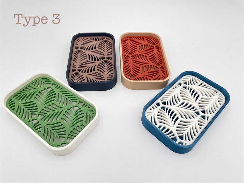 May include: Four rectangular soap dishes with leaf-patterned inserts. Colors include green with white, brown with navy, red with tan, and white with blue. The text "Type 3" is in the upper left corner.