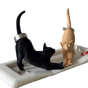 Two cat ring holder dish in black and tan, 3D printed jewelry organizer for cat lovers on a white background