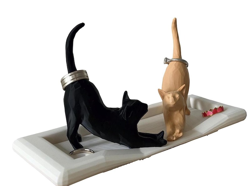 Two cat ring holder dish in black and tan, 3D printed jewelry organizer for cat lovers on a white background