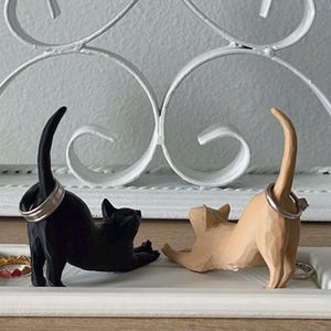 Black and Light Brown Cat on a White plate.