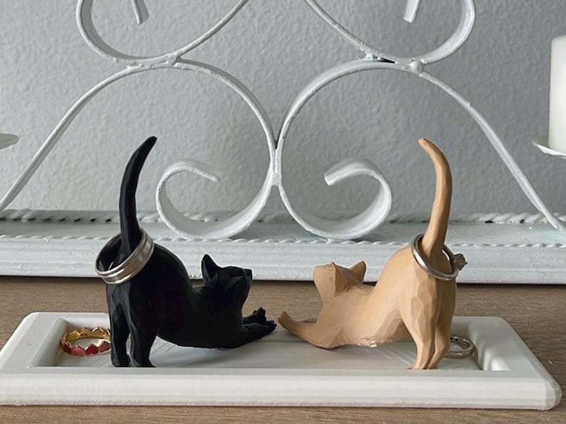 Black and Light Brown Cat on a White plate.