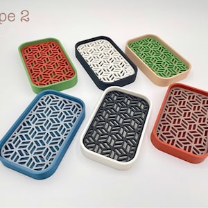 May include: Rectangular trays in various colors, including red, green, blue, and black, with a geometric pattern. The trays have a raised border and a patterned interior. The text "Type 2" is in the upper left corner.
