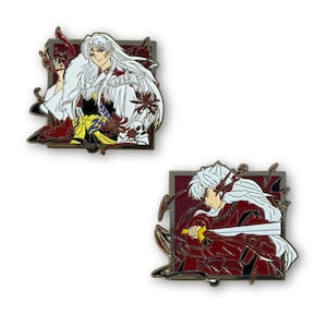 May include: Two enamel pins featuring anime characters. One pin shows a character with long white hair in a white and black outfit, surrounded by red and gold accents. The other pin depicts a character in a red outfit with a sword.