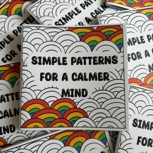 May include: A stack of small, white cards with a rainbow pattern and the text "Simple Patterns for a Calmer Mind".