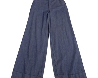 May include: A pair of wide-leg denim pants with a cuffed hem. The pants are a dark blue color and have a high waist.