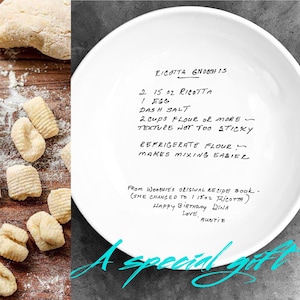 May include: White ceramic bowl with a handwritten ricotta gnocchi recipe. The recipe includes ingredients like ricotta, egg, and flour. The bowl is inscribed with a birthday message and the words "A special gift."