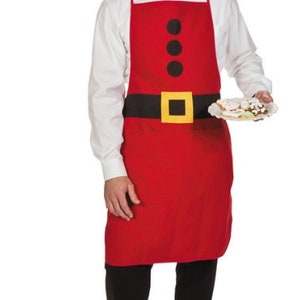 May include: A red apron with a black belt and three black buttons. The apron has a yellow buckle on the belt. A person is wearing the apron and holding a plate of cookies.