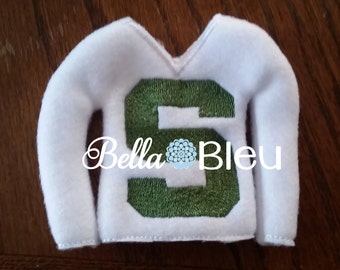 May include: White felt elf-sized sweater with a green felt number "5" on the front. The sweater has a V-neck and long sleeves.