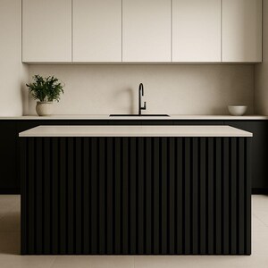 May include: Modern kitchen design featuring a black island with vertical slat detailing. The island has a light-colored countertop. Overhead, there are white cabinets and a black faucet. A potted plant and a white bowl add decorative elements.