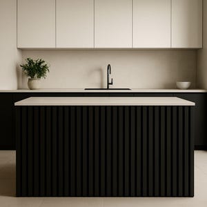 May include: Modern kitchen design featuring a black island with vertical slat detailing. The island has a light-colored countertop. Overhead, there are white cabinets and a black faucet. A potted plant and a white bowl add decorative touches.